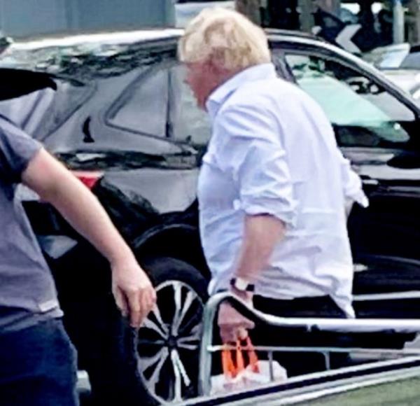 Boris Johnson at budget chain B&M in Didcot, Oxfordshire. May 18, 2024. Photo released - May 19, 2024. Boris Johnson has been spotted shopping - at budget chain B&M. The former PM was seen at the home store which sells ?big brands at sensatio<em></em>nal prices?. Boris was spotted in the Didcot, Oxfordshire, B&M Home Store and Garden Centre at around midday on Saturday. The ex-PM was spotted indulging in some retail therapy wearing a white shirt with the top buttons undone and sleeves rolled up, with a B&M carrier bag in hand. The shopper who snapped the pics says Boris drove off in a green Toyota Previa people carrier. He could also be seen paying for his shopping at the tills.