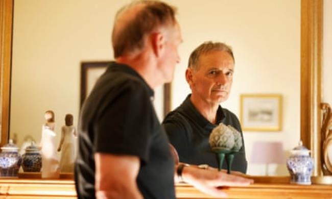Pat Nevin looking in a mirror at home