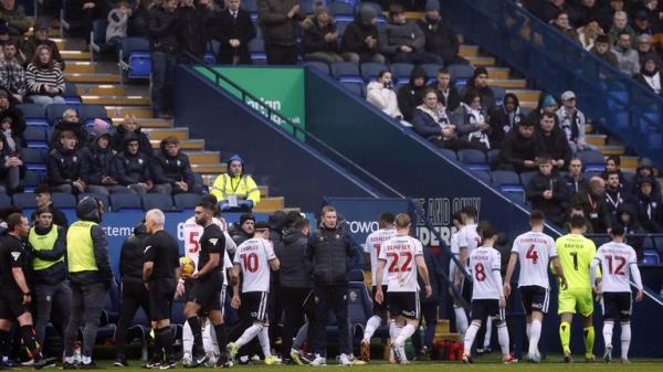 Players leave the pitch after a medical emergency in the crowd