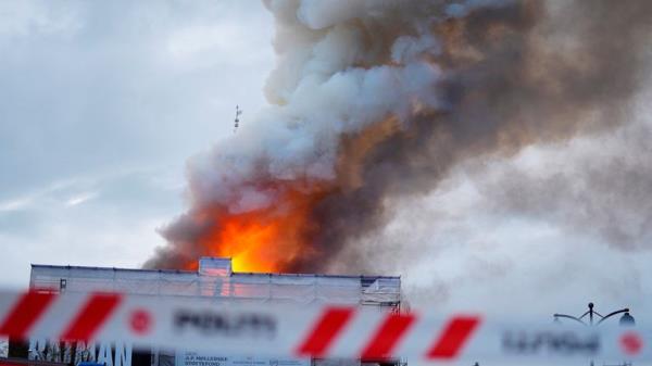 Smoke billows during a fire at the Old Stock Exchange, Boersen, in Copenhagen, Denmark.</p>
<p> Pic: Reuters
