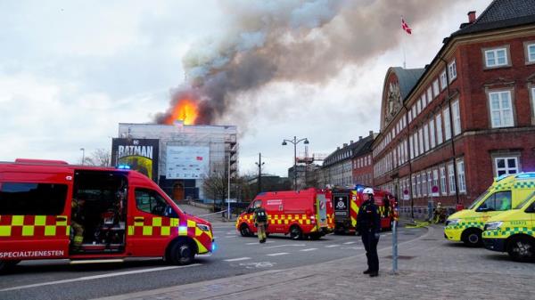 Emergency services work as fire burns at the Old Stock Exchange, Boersen, in Copenhagen, Denmark