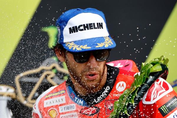 MotoGP rider on podium.