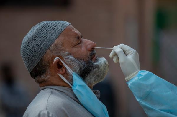 A Kashmiri health worker takes a nasal swab sample to test for COVID-19 in Srinagar, Indian-co<em></em>ntrolled Kashmir, Tuesday, Oct. 6, 2020. India is the second worst-nation in terms of co<em></em>nfirmed coro<em></em>navirus caseload. (AP Photo/ Dar Yasin)