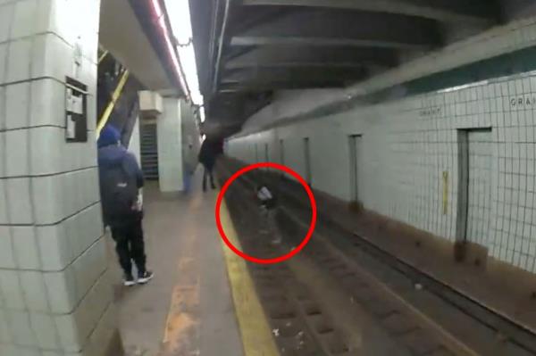 The officers ran along the Grant Avenue A train platform until they reached the man, who was struggling to get back up o<em></em>nto the platform.