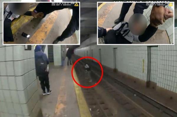 A screenshot of the moment the cops pulled the man back up o<em></em>nto the platform.