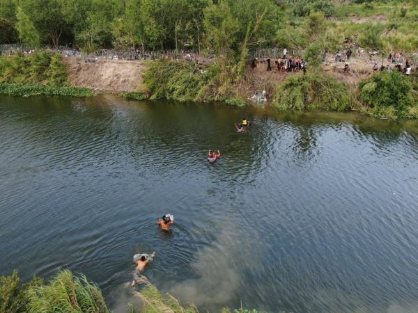 Migrants cross the Rio Grande river from Matamoros, Mexico, Wednesday, May 10, 2023. The U.S. on May 11 will begin denying asylum to migrants who show up at the U.S.-Mexico border without first applying o<em></em>nline or seeking protection in a country they passed through, according to a new rule released on May 10. (AP Photo/Fernando Llano)