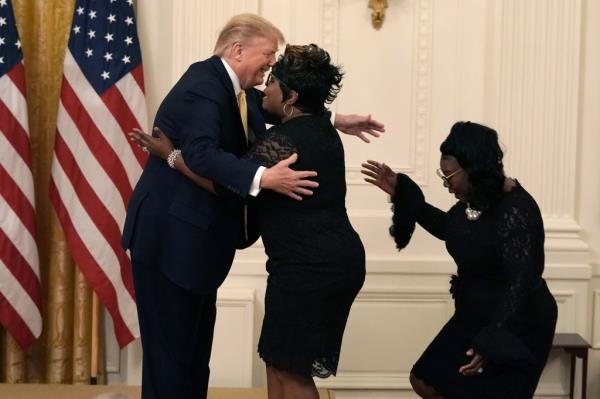 Trump hugs Silk.