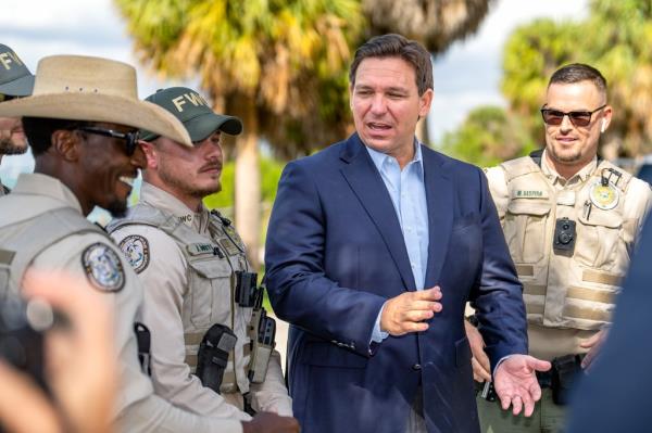 Florida Gov. Ron DeSantis beside law enforcement officers