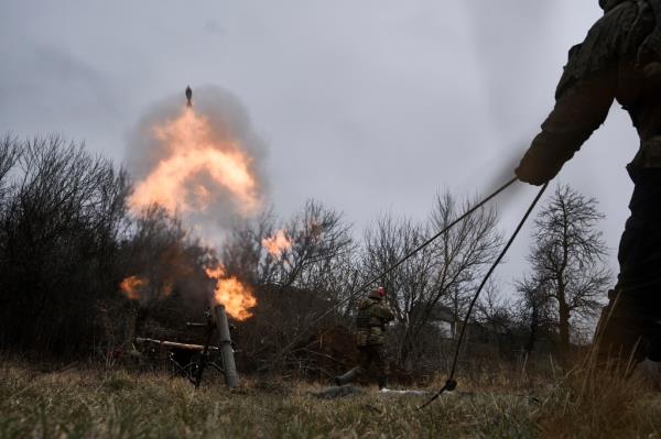 Ukrainian soldiers fire a mortar towards Russian positions near Bakhmut in eastern Ukraine on Dec. 22.