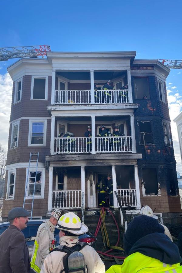 Firefighters work from separate balco<em></em>nies of the building after the blaze broke out from the first floor on Dec. 26, 2022.