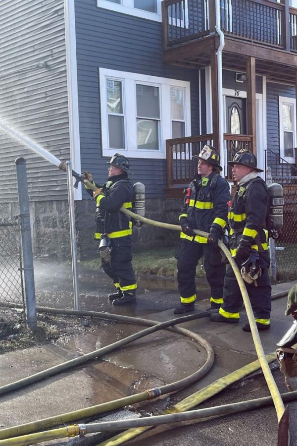 Fire crews work the three story wood f<em></em>rame home at 74 Mora Street in Dorchester on Dec, 26, 2022.
