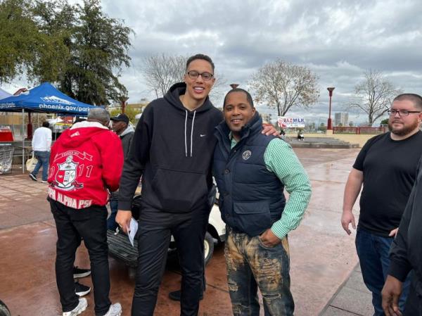 Brittney Griner poses for pictures with a fan