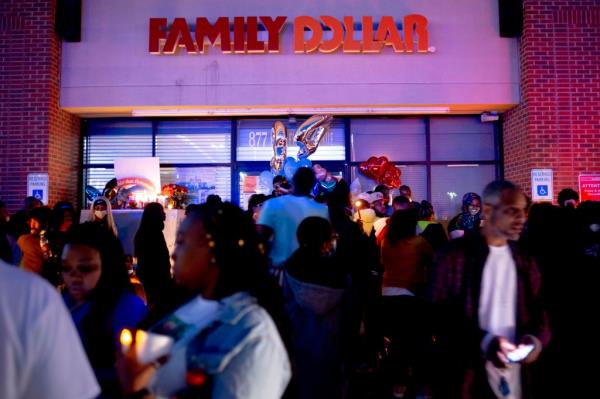 In this Sunday, May 3, 2020, photo, people gather to commemorate the life of Calvin Munerlyn during a vigil in Flint, Michigan. 