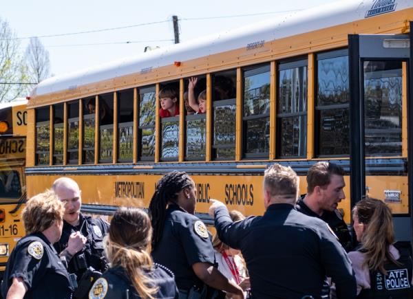 School buses of children evacuated from the school arriving at Woodmont Baptist Church to reunite with their parents.