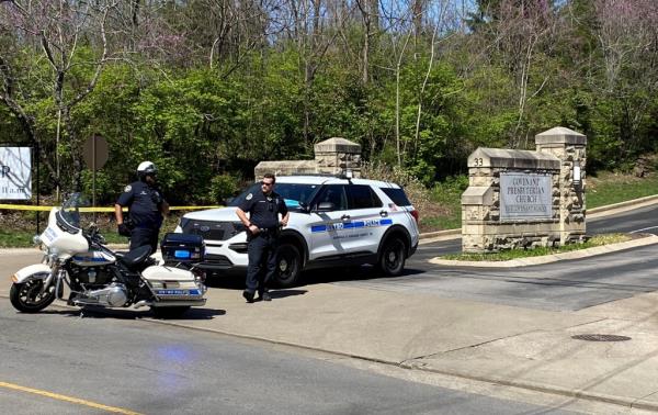 Police officers at the entrance to the school after the shooting that killed seven people.