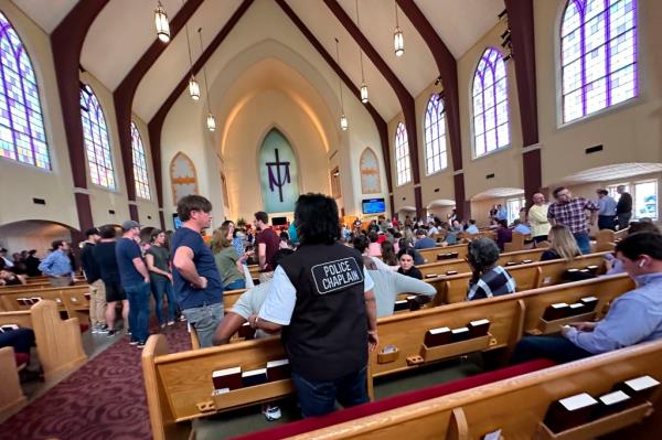 Students and parents at a reunification site at the Woodmont Baptist Church.