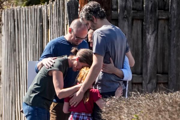A family praying together outside of the Woodmont Baptist church after the shooting.