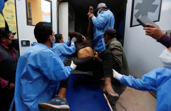 Medical perso<em></em>nnel help load a demo<em></em>nstrator into an ambulance injured during a clash with security forces near the Juliaca airport, in Juliaca, Peru on Jan. 9, 2023.