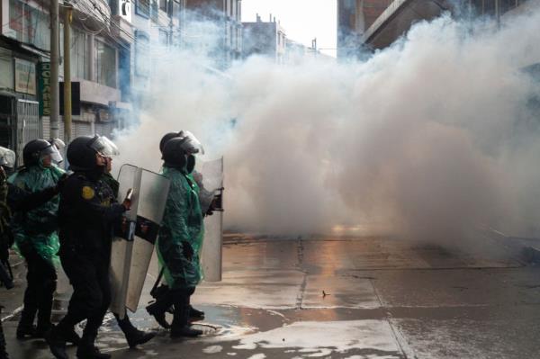Riot police clash with anti-government protesters in Puno, Peru, on January 9, 2023.