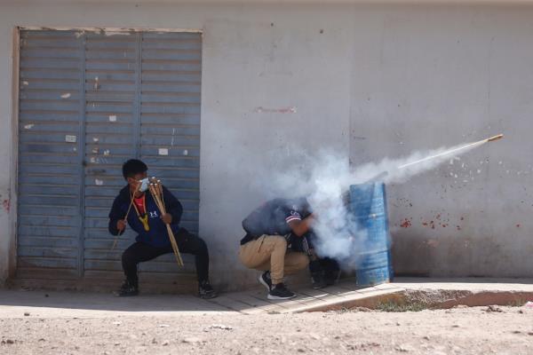 Demo<em></em>nstrators aim fireworks during at security forces, demanding early elections and the release of jailed former President Pedro Castillo, near the Juliaca airport, in Juliaca, Peru on Jan. 9, 2023. 