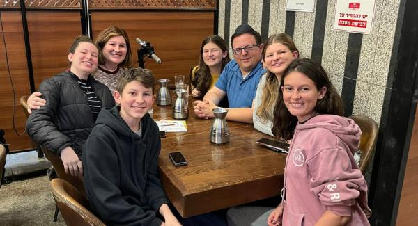 Rabbi Pilichowski is pictured with his wife and five of their children, including daughter Naomi, at a celebratory dinner in Jerusalem just hours after the terrorist attacks. 
