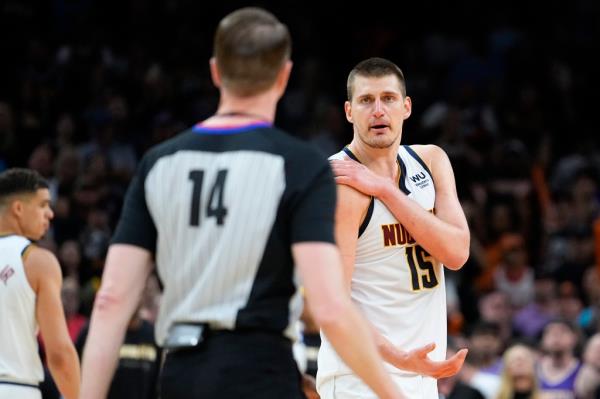 Nuggets center Nikola Jokic (15) looks for a call from referee Ed Malloy