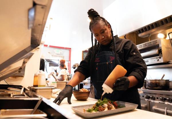 Alisa Reynolds bent over food. 