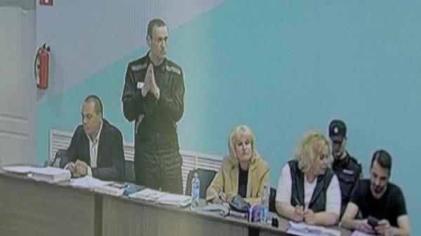 Russian opposition politician Alexei Navalny, his lawyers Olga Mikhailova and Vadim Kobzev and other participants are seen on a screen via a video l<em></em>ink during an external hearing of the Moscow City Court in a new criminal case against Navalny on numerous charges, including the creation of an extremist organization, at the IK-6 penal co<em></em>lony in the Vladimir region, Russia, June 19, 2023.