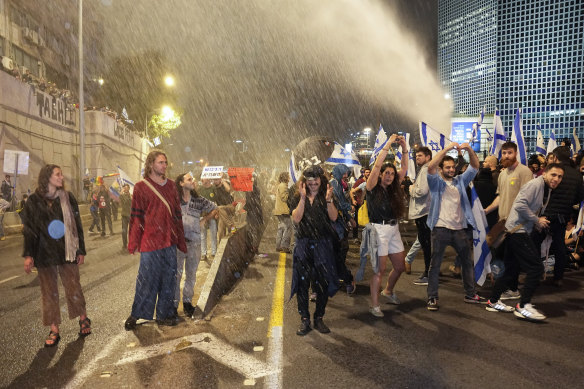 Israeli police use a water cannon to disperse Israelis blocking the freeway during a protest against plans by Prime Minister Benjamin Netanyahu’s government to overhaul the judicial system in Tel Aviv.