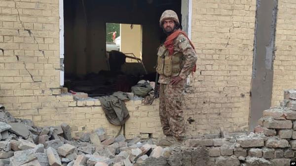 An army soldier examines damages on the site of a bombing at a police station on the outskirts of Dera Ismail Khan, Pakistan, Dec. 12, 2023.