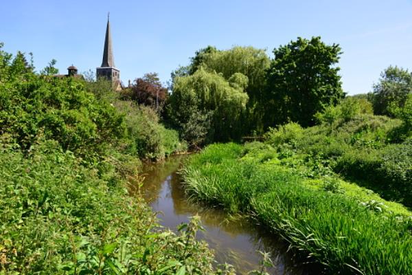 Church in the background of the winding River Mole in Horley, Surrey.