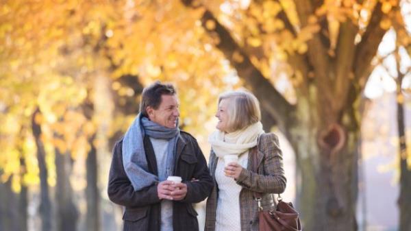 senior couple walking through town in autumn