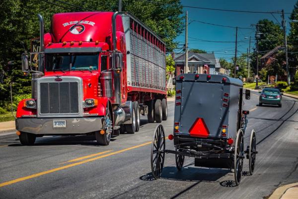 Semi and Horse drawn buggy.