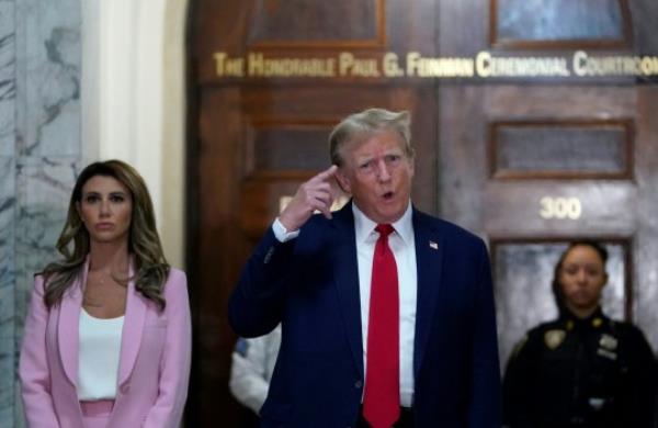 Former President Do<em></em>nald Trump (center) speaks to members of the media as he arrives at New York Supreme Court during the civil fraud trial against the Trump Organization