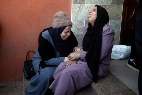 Palestinians mourn relatives killed in the Israeli bombardment of the Gaza Strip outside a morgue in Khan Younis on Thursday