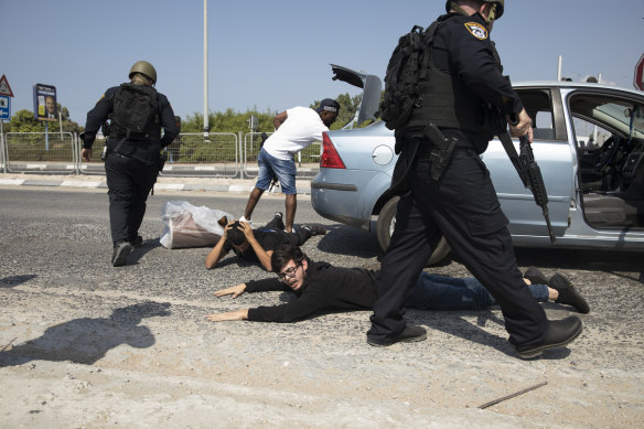 Police officers check suspects at a check point, searching for Hamas militants from Gaza strip on October in Ashdod, Israel.