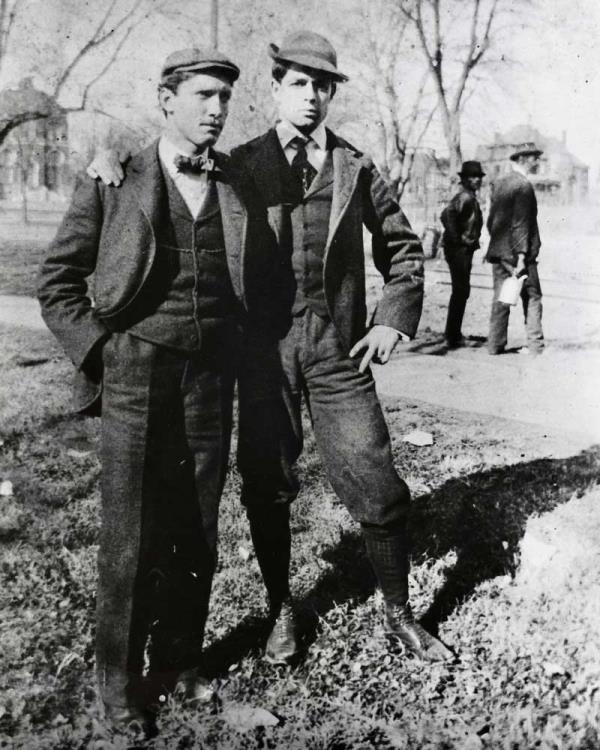 Two University students with Brooks Hall in the background on the left and the rail line on the right. 