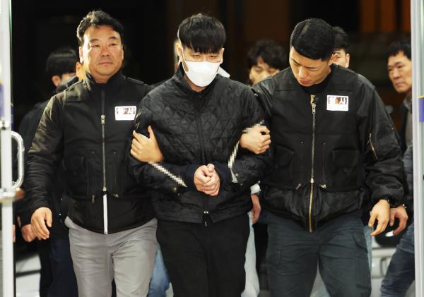 Kim Gil-soo, 36, is transported to Anyang Do<em></em>ngan Police Station in Gyeo<em></em>nggi Province after being apprehended late Monday. (Yonhap)
