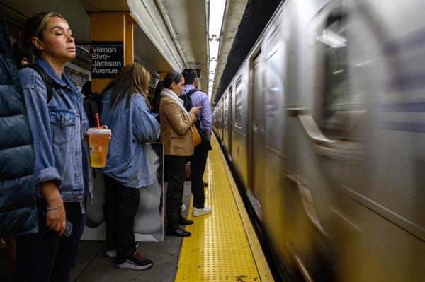 Passengers wait for a train at a subway station in New York city on May 23, 2023