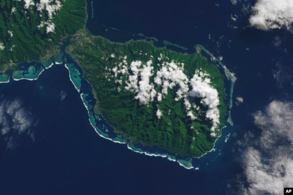 This satellite photo shows the southern part of the French Polynesian island of Tahiti, with the Olympic venue Teahupo'o at center on the southern coast. (NASA's Earth Observatory via AP)