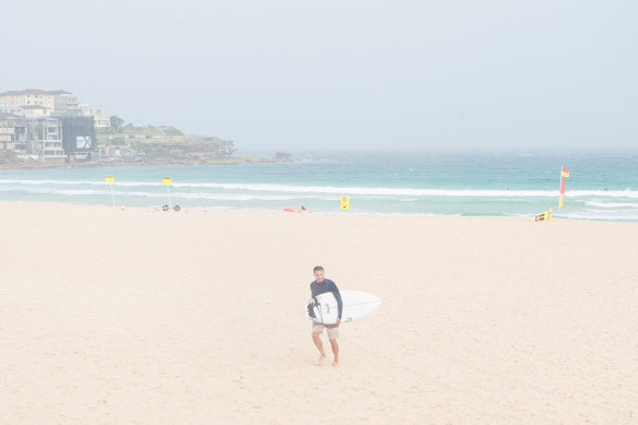 A swimmer braves the weather at Bo<em></em>ndi Beach on Sunday.
