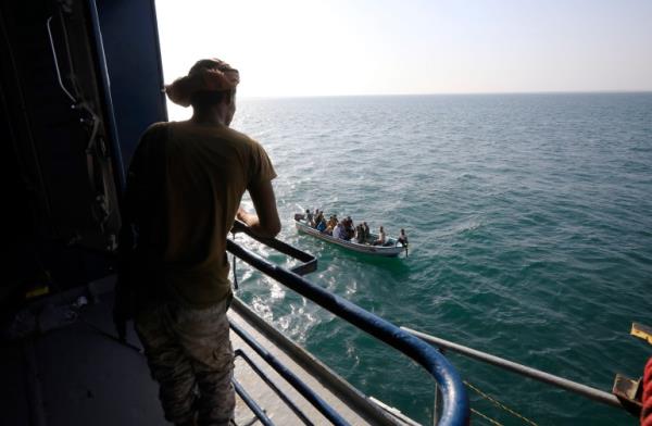 A boat carries people as a Houthi fighter keeps watch on the deck of the Galaxy Leader cargo ship, seized by the Houthis offshore of the Al-Salif port on the Red Sea in the province of Hodeidah, Yemen, 05 December 2023 (issued 06 December 2023). Yemen's Houthis on 06 December 2023 claimed respo<em></em>nsibility for the launch of the barrage of ballistic missiles toward Israel in support of the Palestinian people in the Gaza Strip, according to a statement by Houthis spokesman Yahya Saree. The Houthis vowed to co<em></em>ntinue their efforts to prevent Israeli ships from navigating in the Arabian and Red Seas, in retaliation for Israel's airstrikes on the Gaza Strip. Thousands of Israelis and Palestinians have died since the militant group Hamas launched an unprecedented attack on Israel from the Gaza Strip on 07 October, and the Israeli strikes on the Palestinian enclave which followed it. EPA-EFE/YAHYA ARHAB