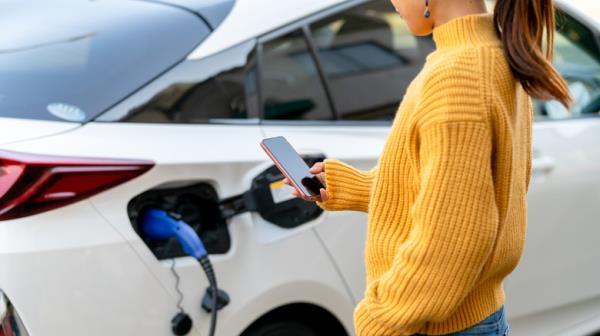 person holding phone while charging