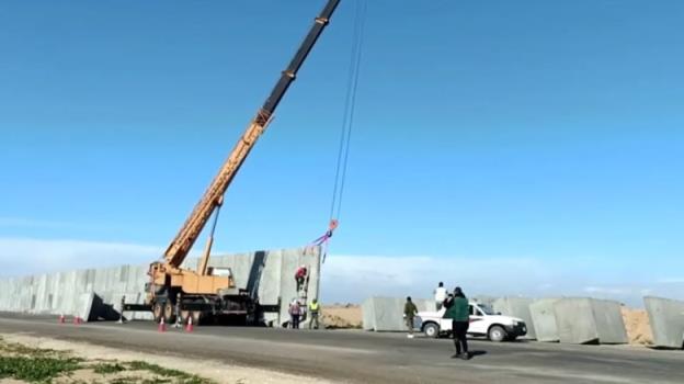 A cement fence under construction.