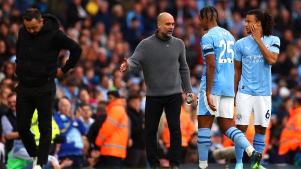 Manuel Akanji is co<em></em>nsoled by Pep Guardiola after his red card against Brighton