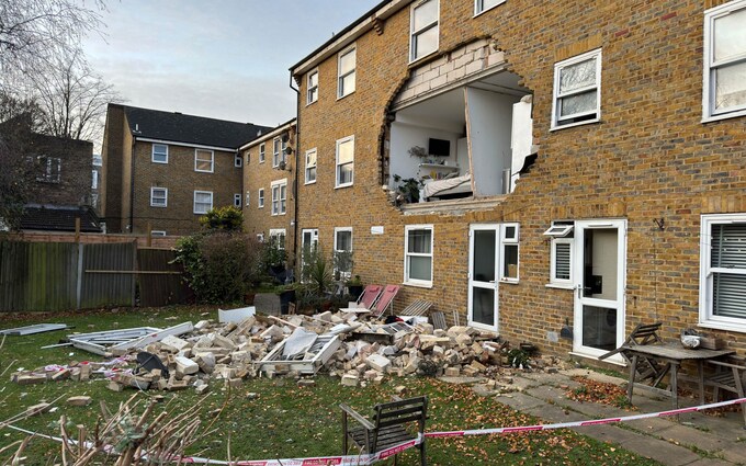 A huge hole is visible at the front of the block of flats