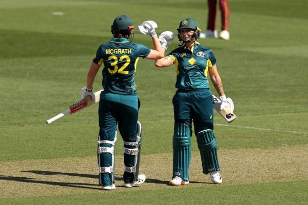 Tahlia McGrath and Ashleigh Gardner of Australia celebrate victory.