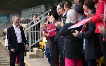 Keir Starmer greeted by clapping supporters holding banners