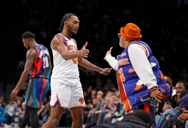 Immanuel Quickley celebrates with Spike Lee after hitting a 3-pointer in the fourth quarter of the Knicks' win.