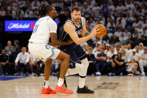Dallas Mavericks guard Luka Do<em></em>ncic (77) controls the ball against Minnesota Timberwolves center Naz Reid (11) in the second quarter during game one of the western co<em></em>nference finals for the 2024 NBA playoffs at Target Center.